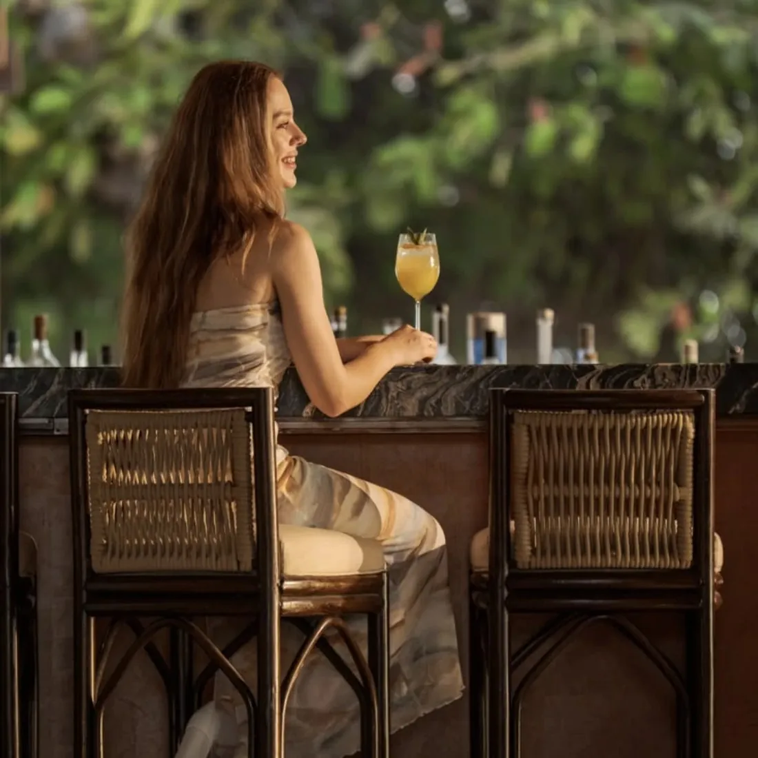 Hotel guest with a cocktail at a resort bar