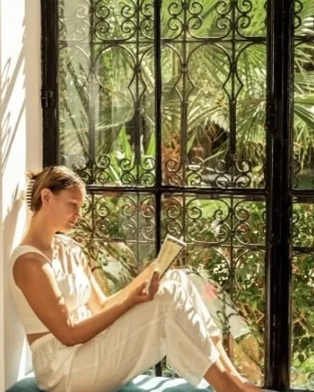 Instagram post of a guest reading by a riad window